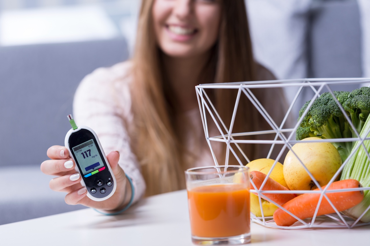 Woman with Diabetes Measuring Blood Sugar & Eating Fresh Vegetables